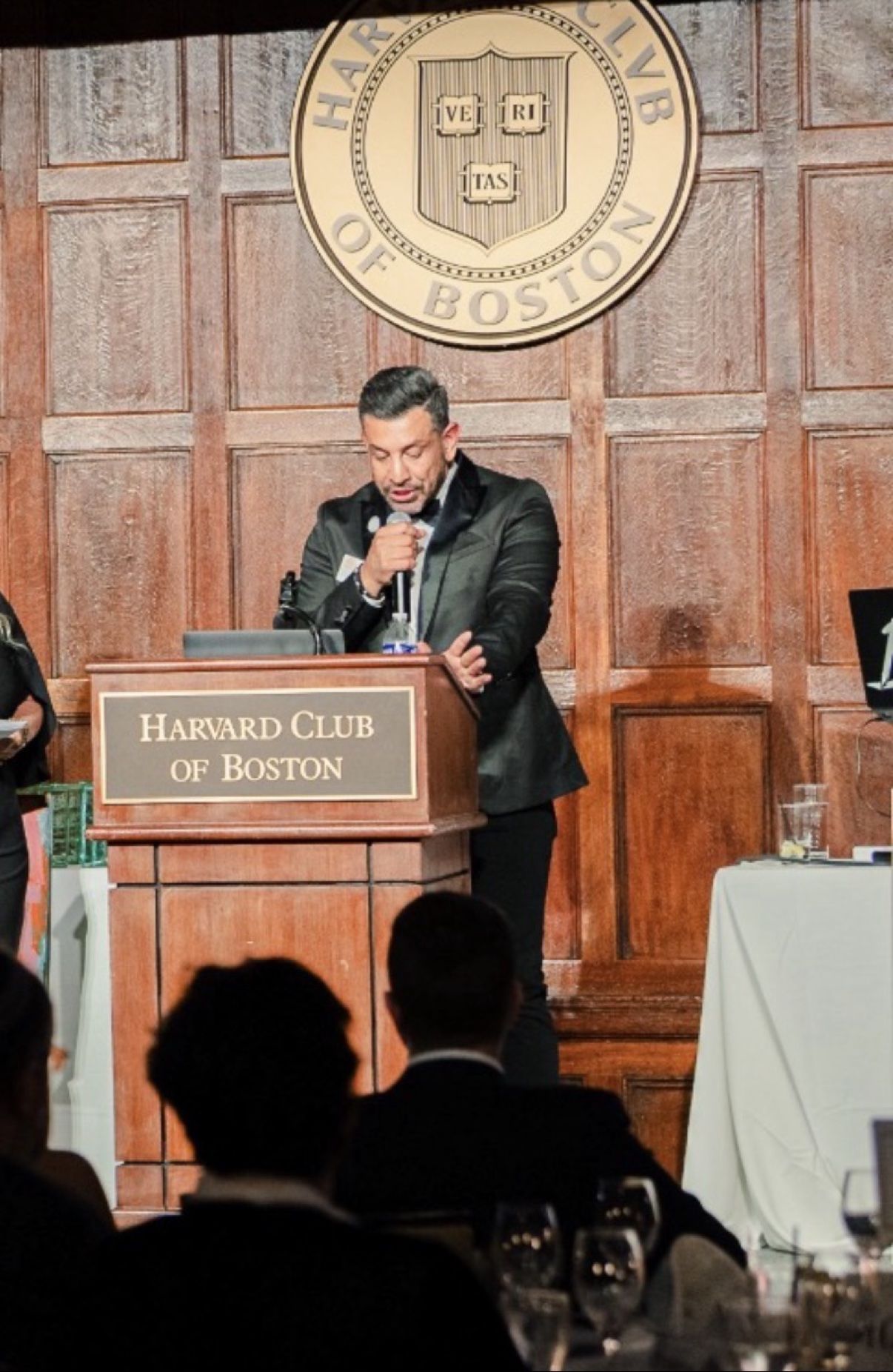 Richie Hosein speaking at the podium at the GHLF annual leadership gala at the Harvard Club of Boston