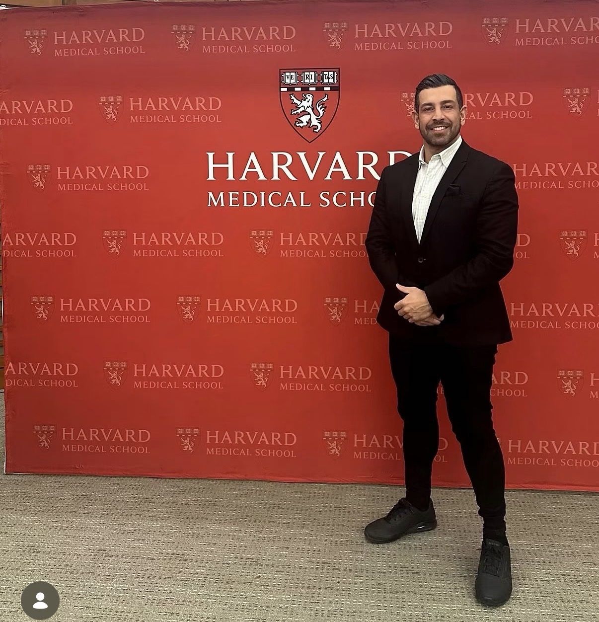 Richie Hosein in front of the Harvard Medical School backdrop during the Global Healthcare Leadership Program